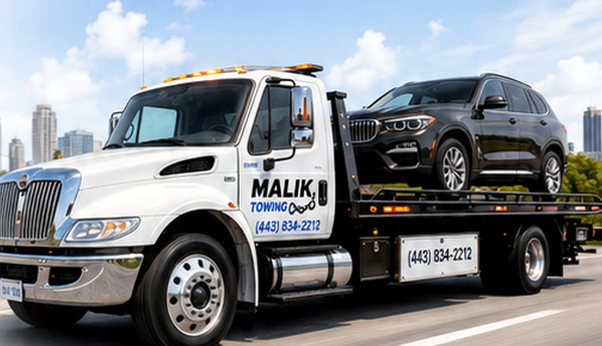 Malik Towing tow truck with the Malik Towing name and phone number